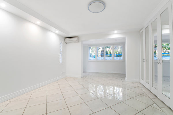 Room with white tile floor and white walls